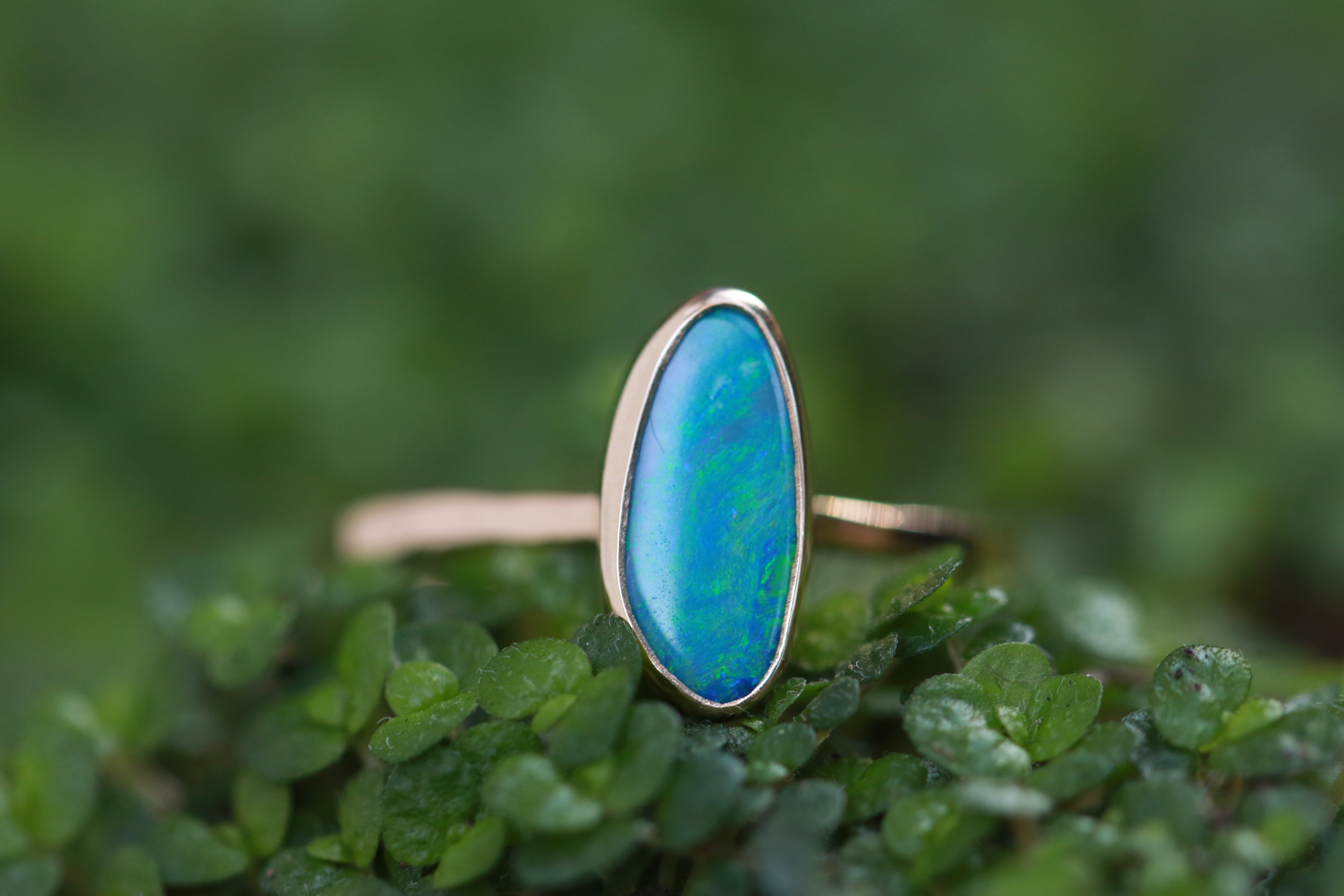 blue opal cabochon ring on greenery