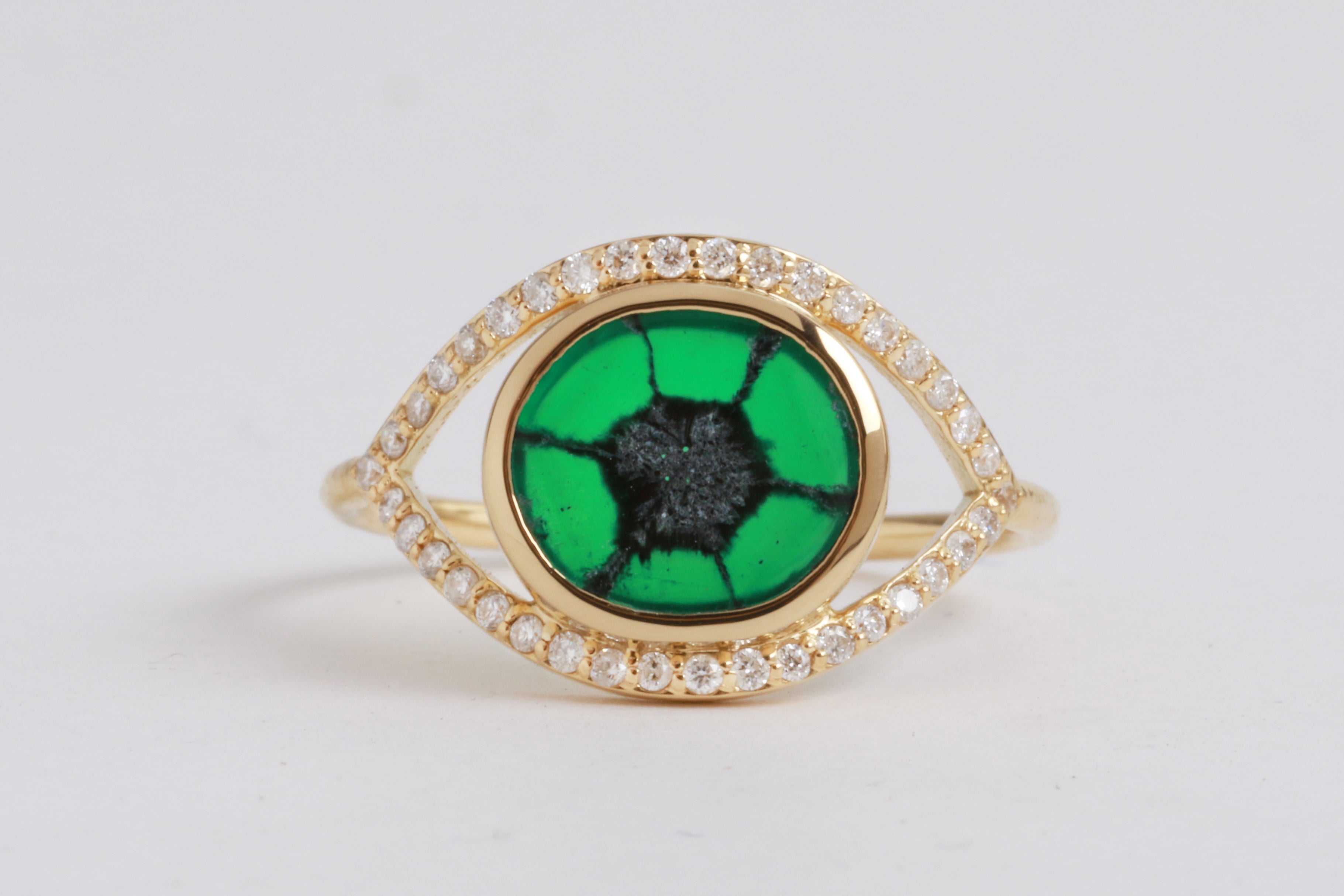 trapiche emerald ring with pavé diamond halo