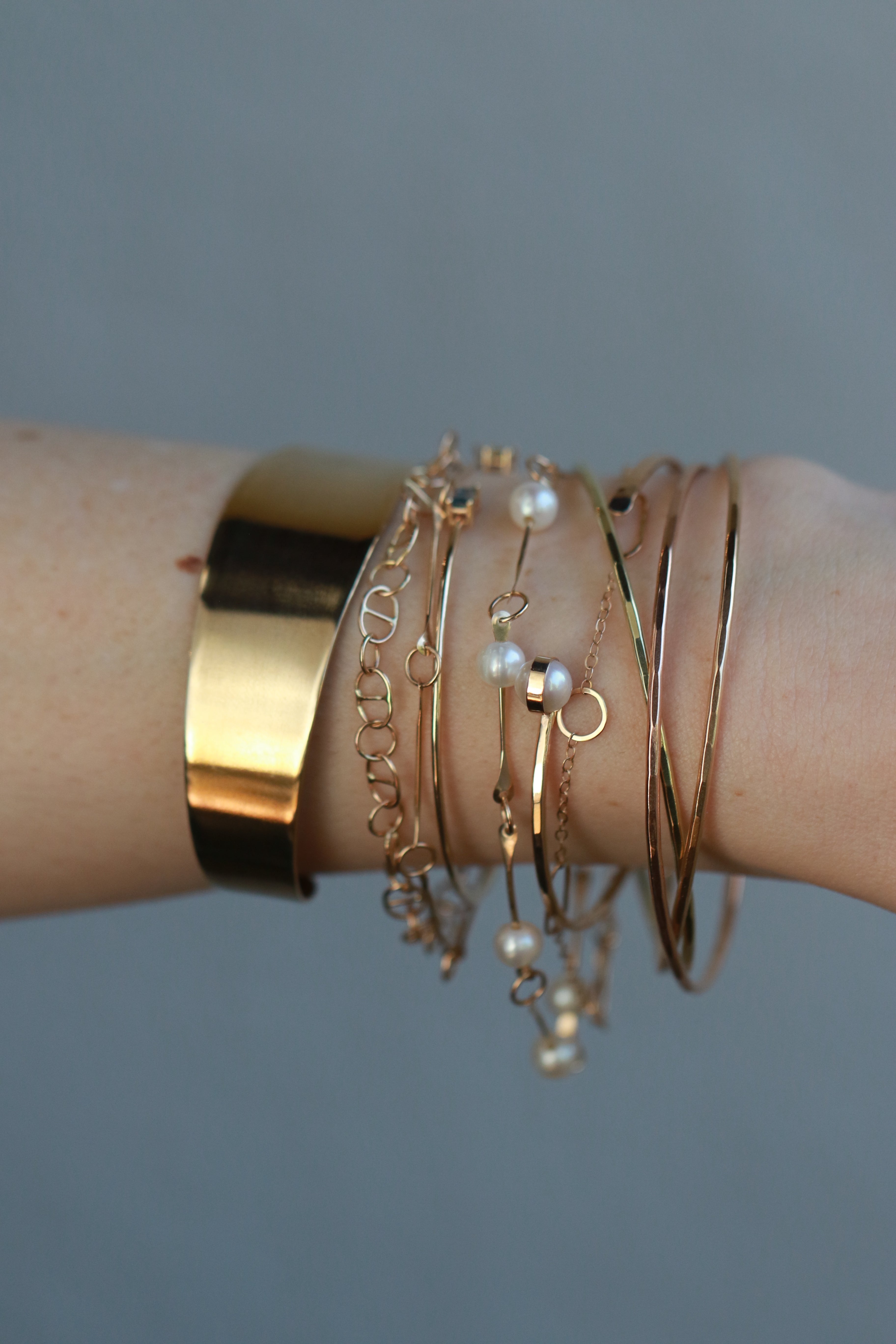 14k gold bracelet stack on a wrist