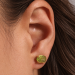 Large Prong Set Herkimer Cut Peridot Stud Earrings Earrings Brunette_Ear_with_Raw_Green_Gemstone
