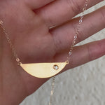 demonstrating the semi circle diamond necklace in motion